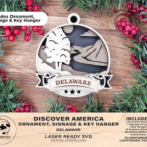May include: Laser cut wooden ornament, signage, and key hanger design featuring a stylized image of a tree and river with the text "DELAWARE" and three stars. The design is part of a "Discover America" series.