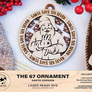 May include: A wooden Christmas ornament featuring Santa Claus winking and making a hand gesture. The text "SANTA SAYS SIX-SEVEN" encircles the Santa image. The ornament is laser-cut with snowflake accents and a hole for hanging. The text "THE 67 ORNAMENT SANTA VERSION" is at the bottom.