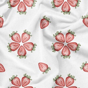May include: A white fabric background with a repeating pattern of red strawberries. The strawberries are cut in half and arranged in a circular pattern.
