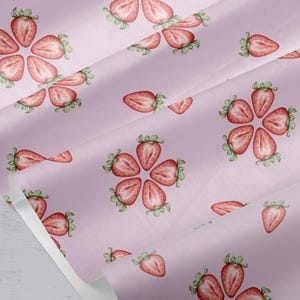 May include: Pink fabric with a repeating pattern of watercolor strawberries. The strawberries are cut in half and arranged in a circular pattern.