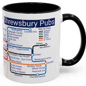 May include: A white ceramic mug with a black handle and interior, displaying a map of Shrewsbury Pubs. The design uses coloured lines and pub names, similar to a transport map. A distinctive gift for pub enthusiasts.