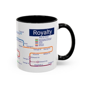 May include: White ceramic mug with a black interior and handle. The mug features a colorful diagram labeled "Royalty" with a key to lines representing different royal houses. The design includes names like George II, Victoria, and Elizabeth II.