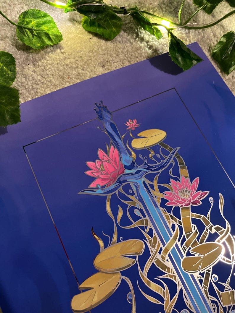 May include: A blue and silver sword with a gold handle is surrounded by pink and white water lilies and gold lily pads on a blue background.