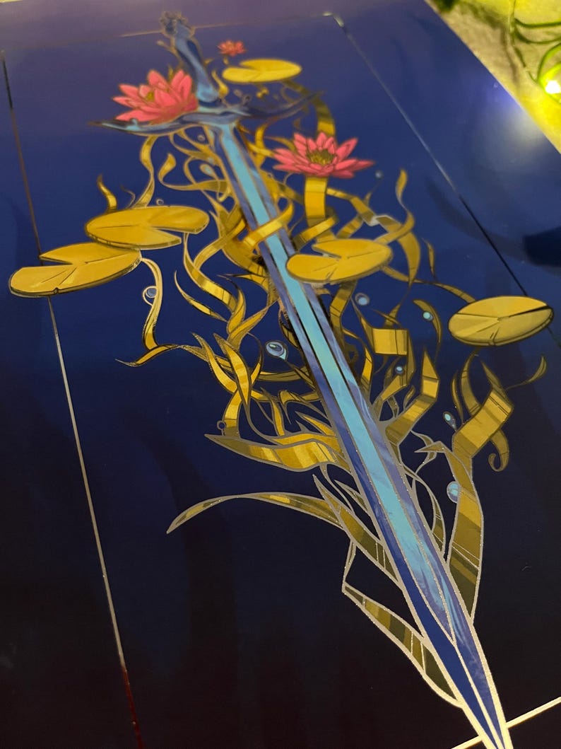 May include: A blue sword with a silver blade is surrounded by gold vines and pink water lilies on a dark blue background.