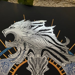 May include: A silver and gold decorative design featuring a roaring lion with intricate details on a black background.