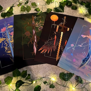 May include: Four prints featuring different sword designs with intricate details. Each print has a unique colour scheme and background, including blue, green, black, and orange.