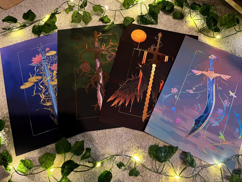 May include: Four prints featuring different sword designs with intricate details. Each print has a unique colour scheme and background, including blue, green, black, and orange.