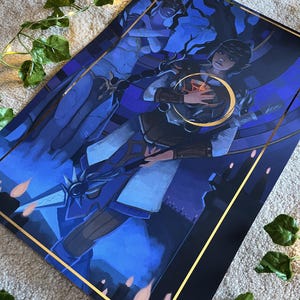 May include: A blue and gold framed print of a woman holding a glowing orb. The woman is wearing a white and blue dress and a gold crown. The background is a dark blue and purple sky with stars.
