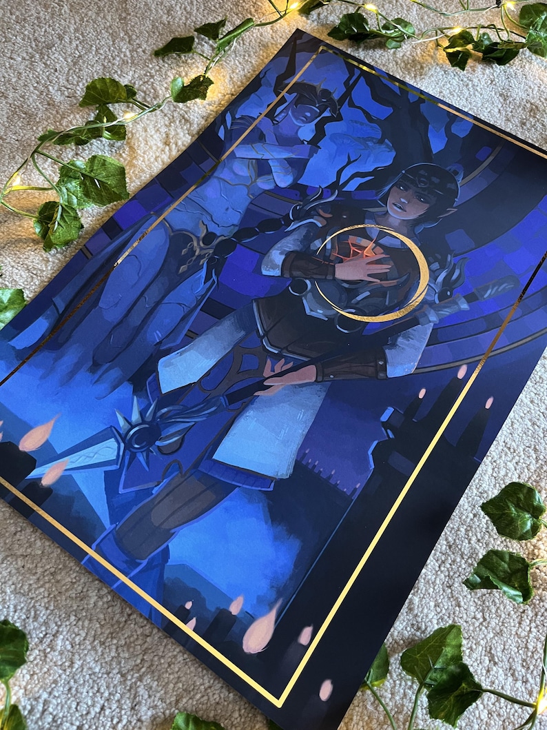 May include: A blue and gold framed print of a woman holding a glowing orb. The woman is wearing a white and blue dress and a gold crown. The background is a dark blue and purple sky with stars.