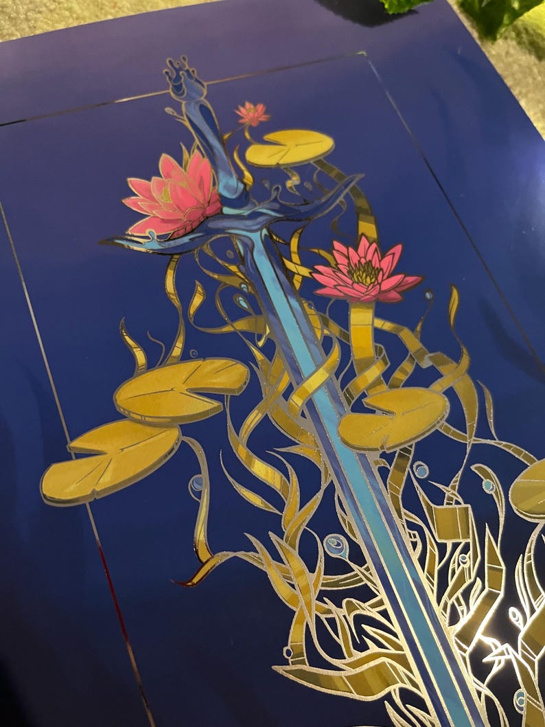 May include: A blue sword with a silver hilt is surrounded by gold and pink water lilies on a dark blue background.
