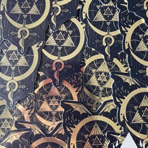 Piles of the Mirror Gold sticker are arranged in a pattern, showing the product in quantity. Icewreath's shop logo is placed in the corner.