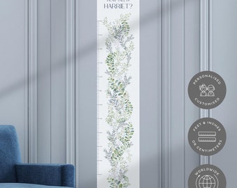 May include: A white growth chart with a green leafy design. The chart is labeled "How Tall is Harriet?" and includes measurements in inches and centimeters. The chart is personalized and can be customized. It also offers worldwide shipping.
