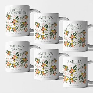 May include: Six white ceramic mugs with a floral design featuring orange blossoms, leaves, and lemons. Each mug has a different name on it, including "Amelia's Godmother", "Amelia's Auntie", "Amelia's Nanna", "Amelia's Grandma", "Amelia's Mummy", and "Amelia".