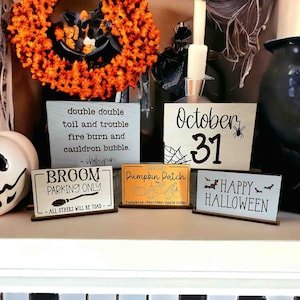 May include: Four wooden signs with Halloween themes. The signs are decorated with black paint and feature text such as "double double toil and trouble", "Broom Parking Only", "October 31", "Pumpkin Patch", and "Happy Halloween".