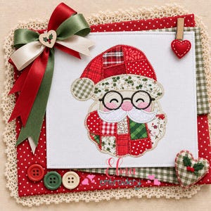 May include: A white fabric square featuring a machine-embroidered Santa Claus face with patchwork-style patterns in red, green, and white. The design includes a large multi-layered ribbon bow, three round buttons, and two heart-shaped fabric accents.