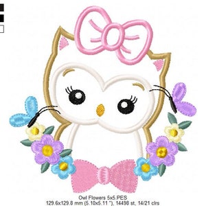 May include: Embroidered design of a white owl with pink bow and flowers. The owl has large black eyes and a small beak. The flowers are in shades of pink, purple, blue, and yellow. The design is 5 inches by 5 inches and has 14,498 stitches.