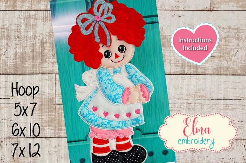 May include: An embroidered Raggedy Ann doll design with red yarn hair, a blue bow, and a blue floral dress. The design includes the text "Instructions Included" and is available in 5x7, 6x10, and 7x12 inch hoop sizes.