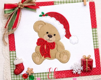 May include: An embroidered tan teddy bear wearing a red and white Santa hat and a red bow, centered on a white square fabric patch. The patch is framed by red and green checkered fabric, a red ribbon bow, a stocking, and a gift box.