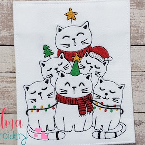 May include: Embroidered design of a Christmas tree made of white cats wearing red scarves and hats. The top cat has a star on its head and the bottom cats have Christmas lights around them.