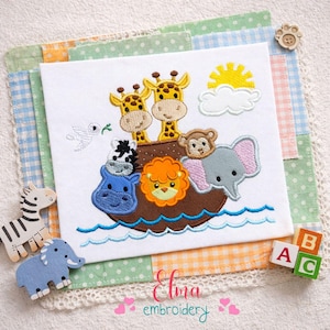 May include: Embroidered design featuring giraffes, a zebra, a lion, a monkey, an elephant, and a hippo on a brown ark, with a sun and cloud. The design is on a white background with blue water, surrounded by a patchwork quilt.