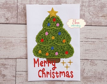 May include: Embroidered design of a green Christmas tree with colorful ornaments and a gold star on top. The text "Merry Christmas" is below the tree with gold stars.