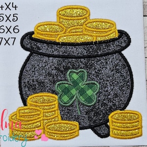 May include: A black pot filled with gold coins and a green shamrock. The pot has a handle and a base. The coins are stacked on top of each other. The shamrock is a symbol of good luck.