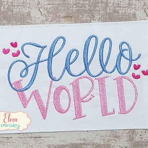 May include: Embroidered design on white fabric with the text "Hello World" in blue and pink lettering. There are small pink hearts on either side of the text.