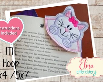 May include: A white cat bookmark with pink ears, a pink bow, and a white face. The bookmark is in a 4x4 or 5x7 hoop. Instructions are included.