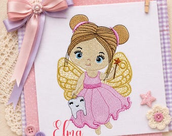 May include: An embroidered design featuring a fairy in a pink dress, holding a tooth and a magic wand. The fairy has golden wings and brown hair. The design includes the text "Elma embroidery" in pink, with a decorative bow and buttons.