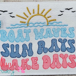 May include: Embroidered design with the text "Boat Waves Sun Rays Lake Days" in a retro font. The design features a yellow sun, blue waves, and blue and pink letters. The design is available in four sizes: 5x7, 5x8, 6x10, and 7x12 inches.