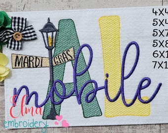 May include: Embroidered design of the word "Mobile" with a green "A" and a yellow "L". The design also includes a street sign that says "Mardi Gras" and a lamppost. The design is available in sizes 4x4, 5x4, 5x7, 5x8, 6x10, and 7x12 inches.