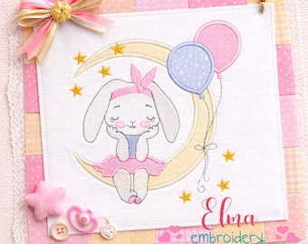 May include: Embroidered artwork featuring a bunny sitting on a crescent moon, holding two balloons. The design includes stars, a pink bow, and the text "Elma embroidery". The color palette includes pink, yellow, and blue.