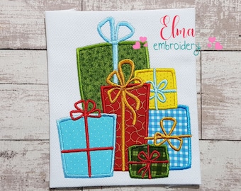 May include: A stack of five colorful gift boxes with bows. The boxes are green, red, yellow, blue, and green with red and white plaid. The boxes are embroidered with a white background.