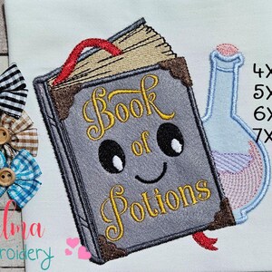 May include: An embroidered design featuring a smiling book labeled "Book of Potions" with a potion bottle. The book is gray with gold lettering and brown trim. Three decorative bows with wooden buttons are on the left.