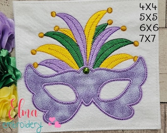 May include: Purple Mardi Gras mask with yellow, green, and purple feathers. The mask is embroidered on white felt. The text 4x4, 5x5, 6x6, 7x7 is visible in the upper right corner of the image.