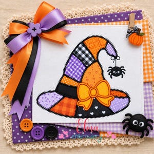 May include: A white fabric square featuring an embroidered patchwork witch hat in orange, purple, and black with a yellow bow and a hanging spider. The design includes a large orange and purple ribbon bow, three colorful buttons, and a small spider.