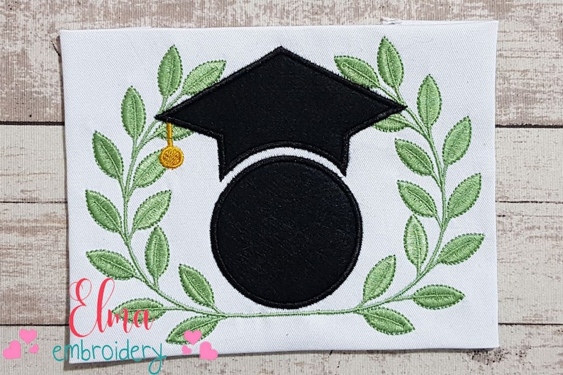May include: Black graduation cap with a gold tassel, surrounded by a green laurel wreath. The cap is over a black circle with space for personalization.
