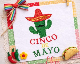 May include: A Cinco de Mayo themed design featuring a green cactus wearing a red sombrero with a black mustache. The words "Cinco de Mayo" are embroidered in red and green. A rainbow ribbon and decorative chili peppers and a taco are also included.
