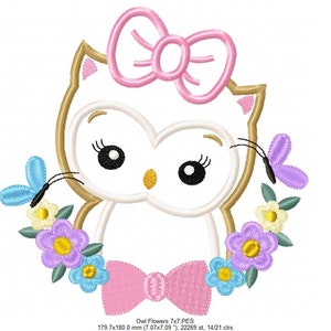 May include: Embroidered design of a white owl with a pink bow, surrounded by a wreath of colorful flowers and butterflies. The owl has large black eyes and a pink bow around its neck. The design is 7 inches by 7 inches and has 14 colors.