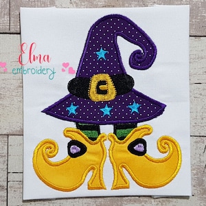 May include: Embroidered witch with a purple hat with stars and a black belt, and yellow shoes with curled toes.
