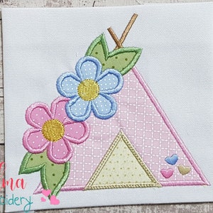 May include: Embroidered design of a pink and white tent with a blue and white flower, green leaves, and pink hearts. The design is perfect for a nursery or child's room.