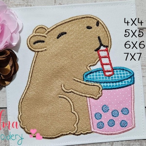 May include: Embroidered patch featuring a cartoon capybara drinking from a pink bubble tea cup with blue boba. The patch is on a white background with the text "4X4, 5X5, 6X6, 7X7".