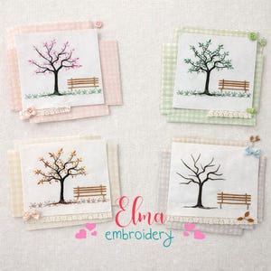 May include: Four embroidered squares featuring trees with benches, each on a different colored gingham background. The trees display seasonal changes: spring blossoms, summer leaves, autumn foliage, and winter bare branches. The text "Elma embroidery" is also visible.