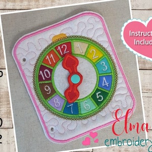 May include: A colorful, embroidered, felt spinner with numbers 1 through 12. The spinner is designed for a 5x7, 5x8, 6x10, or 7x12 hoop. Instructions are included. The image includes the text "Elma embroidery".