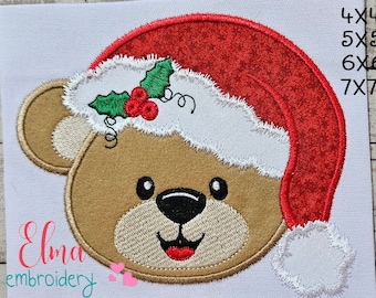 May include: Embroidered design of a brown teddy bear wearing a red Santa hat with white trim and a green holly sprig. The design is available in four sizes: 4x4, 5x5, 6x6, and 7x7 inches.