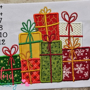 May include: A stack of embroidered Christmas presents in various colors and patterns, including red, green, gold, and white. The presents are arranged in a pyramid shape, with the largest present at the bottom and the smallest present at the top. The presents are decorated with bows, ribbons, and snowflakes.