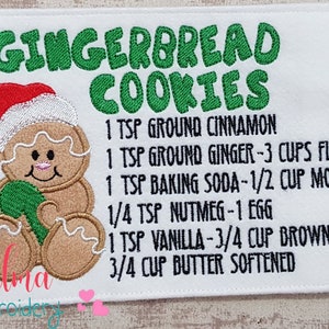 May include: Embroidered kitchen tea towel featuring a gingerbread man and the text "GINGERBREAD COOKIES" along with a recipe for gingerbread cookies. The recipe includes 1 teaspoon ground cinnamon, 1 teaspoon ground ginger, 3 cups plain flour, 1 teaspoon baking soda, 1/2 cup molasses, 1/4 teaspoon nutmeg, 1 egg, 1 teaspoon vanilla extract, 3/4 cup brown sugar, and 3/4 cup softened butter.