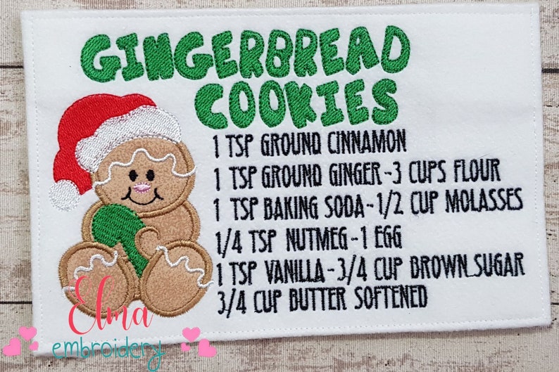 May include: Embroidered kitchen towel with a gingerbread man and the text "GINGERBREAD COOKIES" and a recipe for gingerbread cookies. The recipe includes 1 teaspoon ground cinnamon, 1 teaspoon ground ginger, 3 cups flour, 1 teaspoon baking soda, 1/2 cup molasses, 1/4 teaspoon nutmeg, 1 egg, 1 teaspoon vanilla, 3/4 cup brown sugar, and 3/4 cup butter softened.