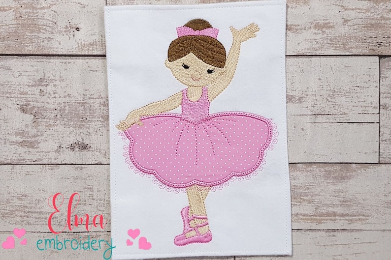 May include: Embroidered design of a ballerina with brown hair, wearing a pink tutu with white polka dots and pink ballet shoes.