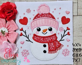 May include: Embroidered design of a snowman wearing a pink hat and red scarf with hearts and snowflakes. The design is available in sizes 4x4, 5x5, 6x6, and 7x7 inches.